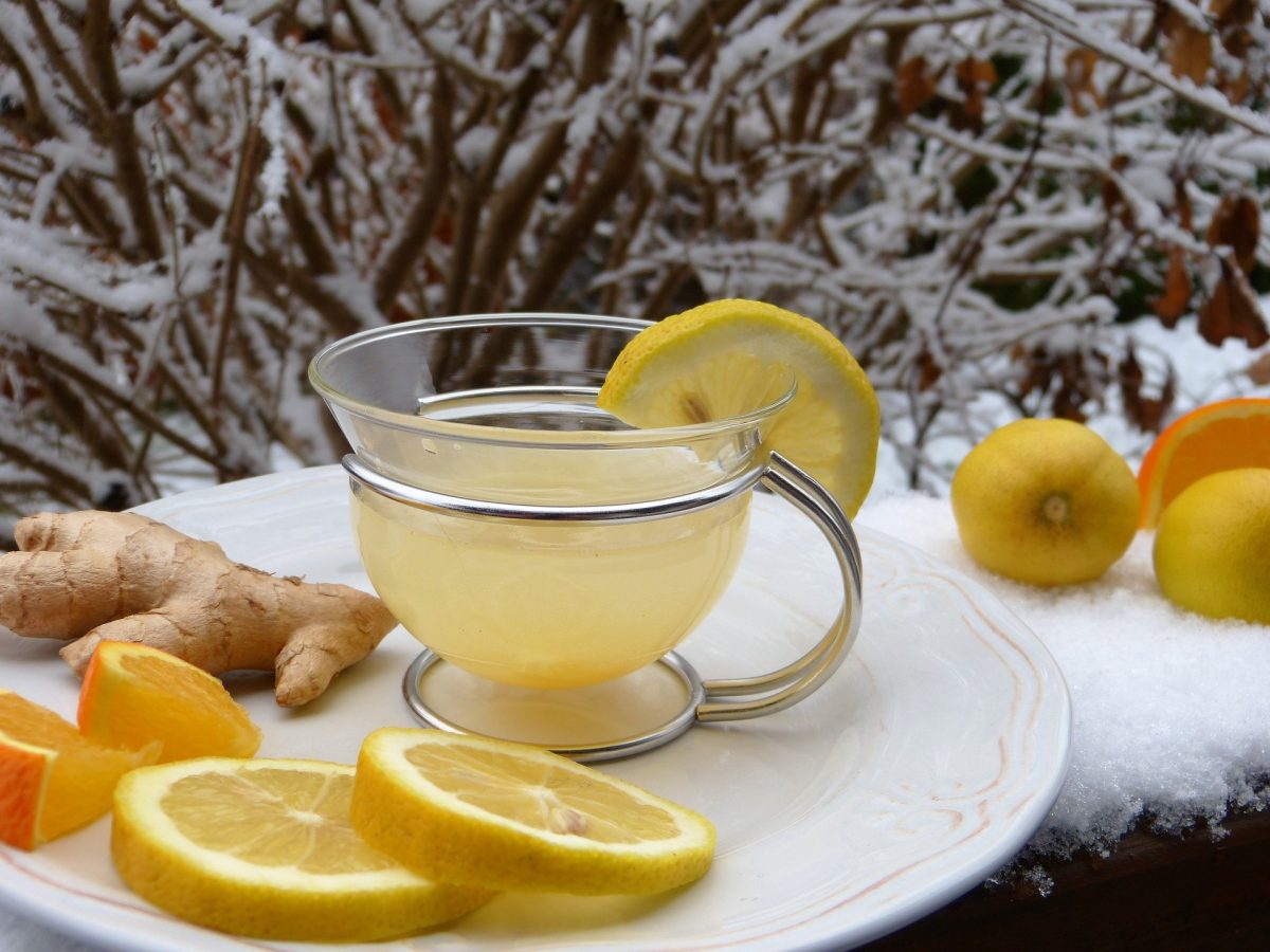 Lemon, orange and ginger tea on plate outside in the winter - Nasal Congestion and Sleep Apnoea | SleepTest.co.uk