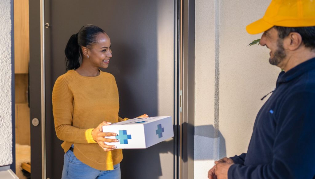 woman receiving parcel from post man | Sleeptest.co.uk